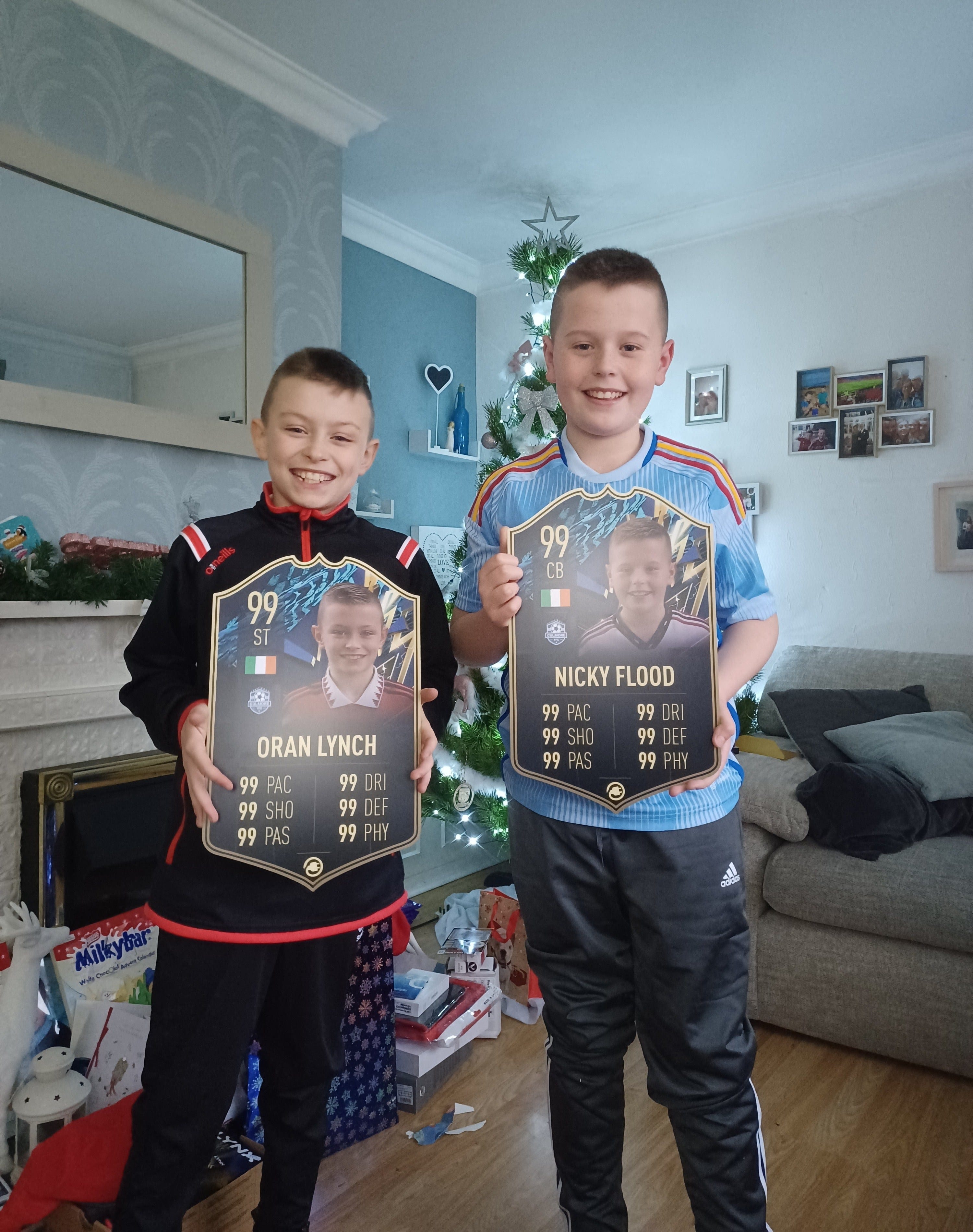 Two young CardsPlug customers holding personalised cards
